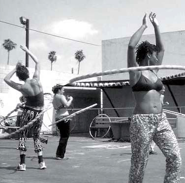 Hula-hoopers practice their skills at the Gathering of the Tribes - MAPS Bulletin Winter 2003 - Holy Fire